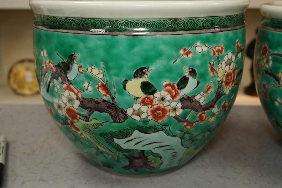 A pair of Chinese famille verte green ground jardinieres, Kangxi marks, but late 19th century